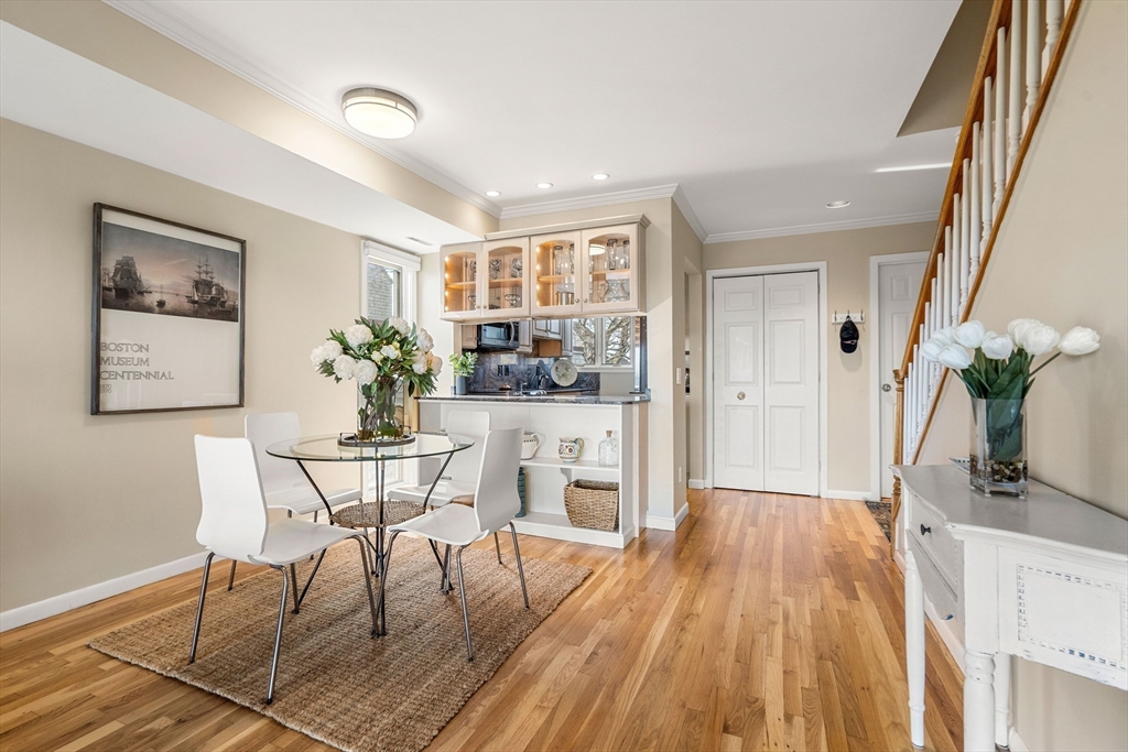 55 Brackett Place, Unit D Marblehead, MA 01945 - Photo 8 of 34 a dining room with furniture and wooden floor