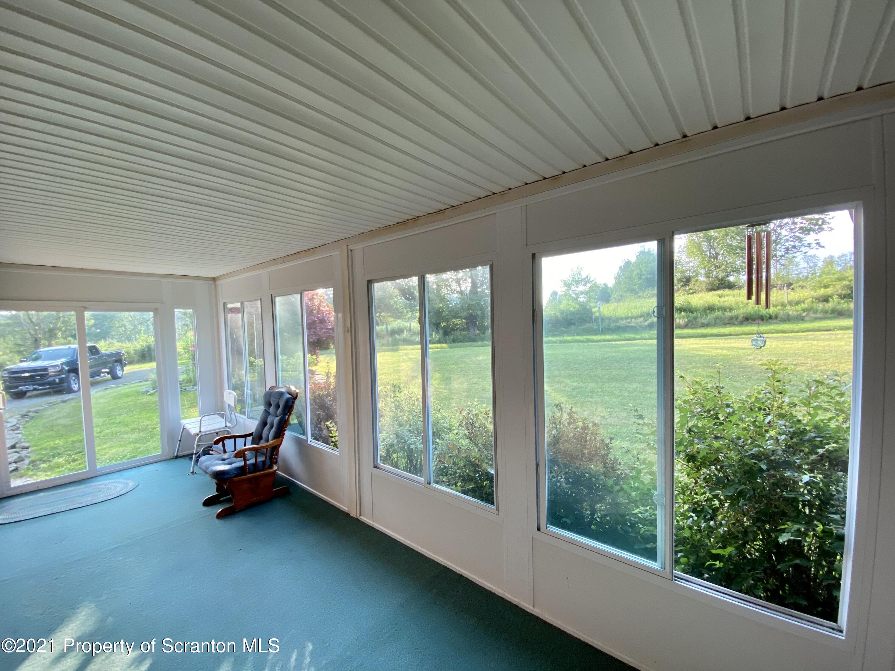 64 Thistle Hill Road Nicholson, PA 18446 - Photo 27 of 47 a living room with furniture and a large window