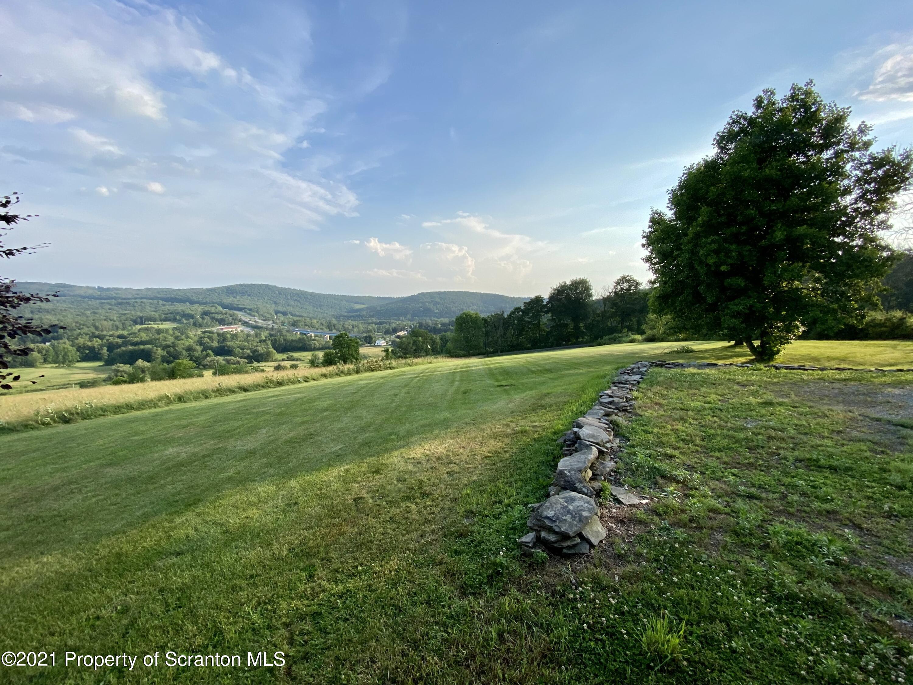 64 Thistle Hill Road Nicholson, PA 18446 - Photo 3 of 47 a view of a golf course with a garden