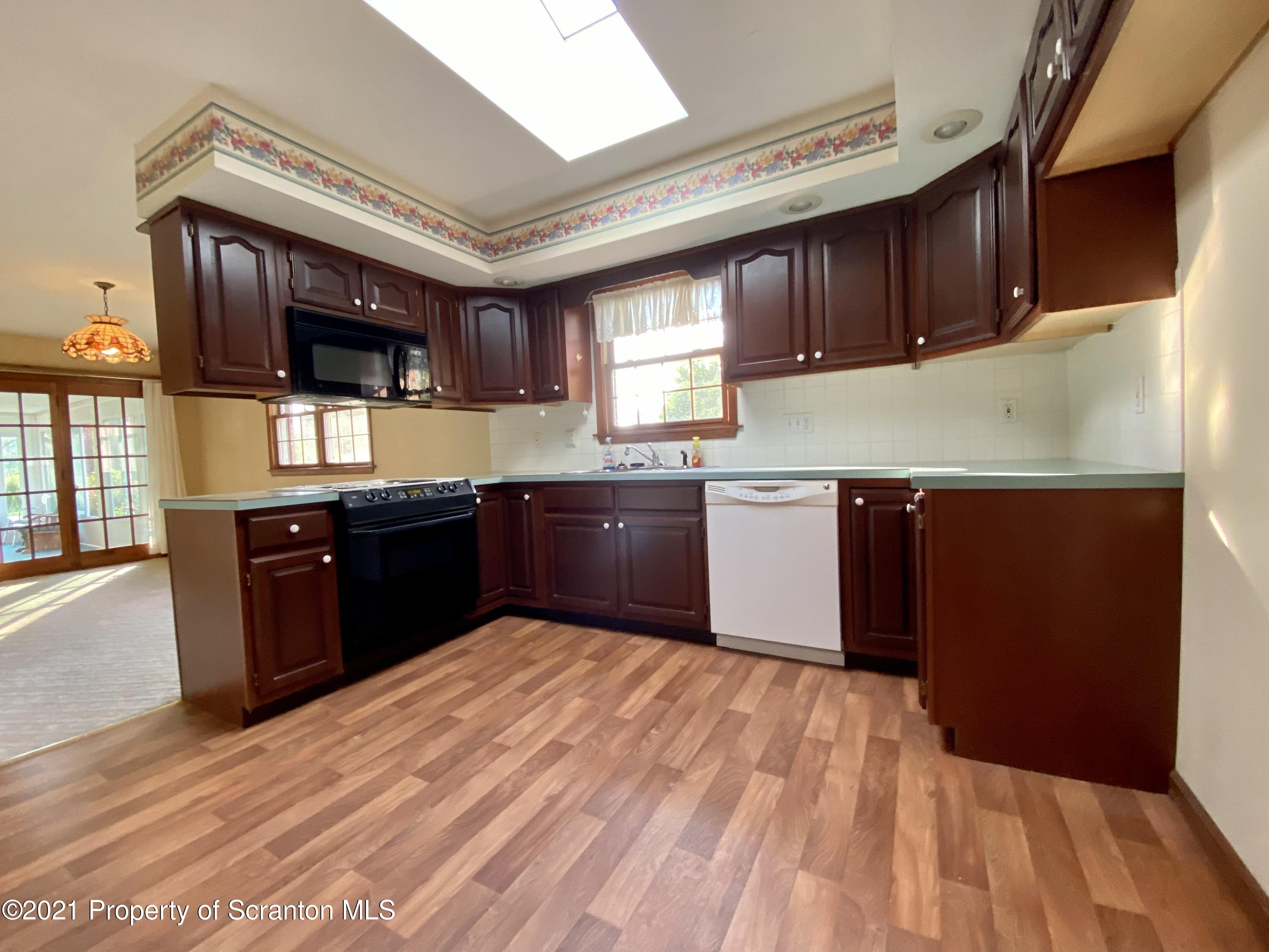 64 Thistle Hill Road Nicholson, PA 18446 - Photo 8 of 47 a kitchen with stainless steel appliances wooden cabinets a sink and a stove