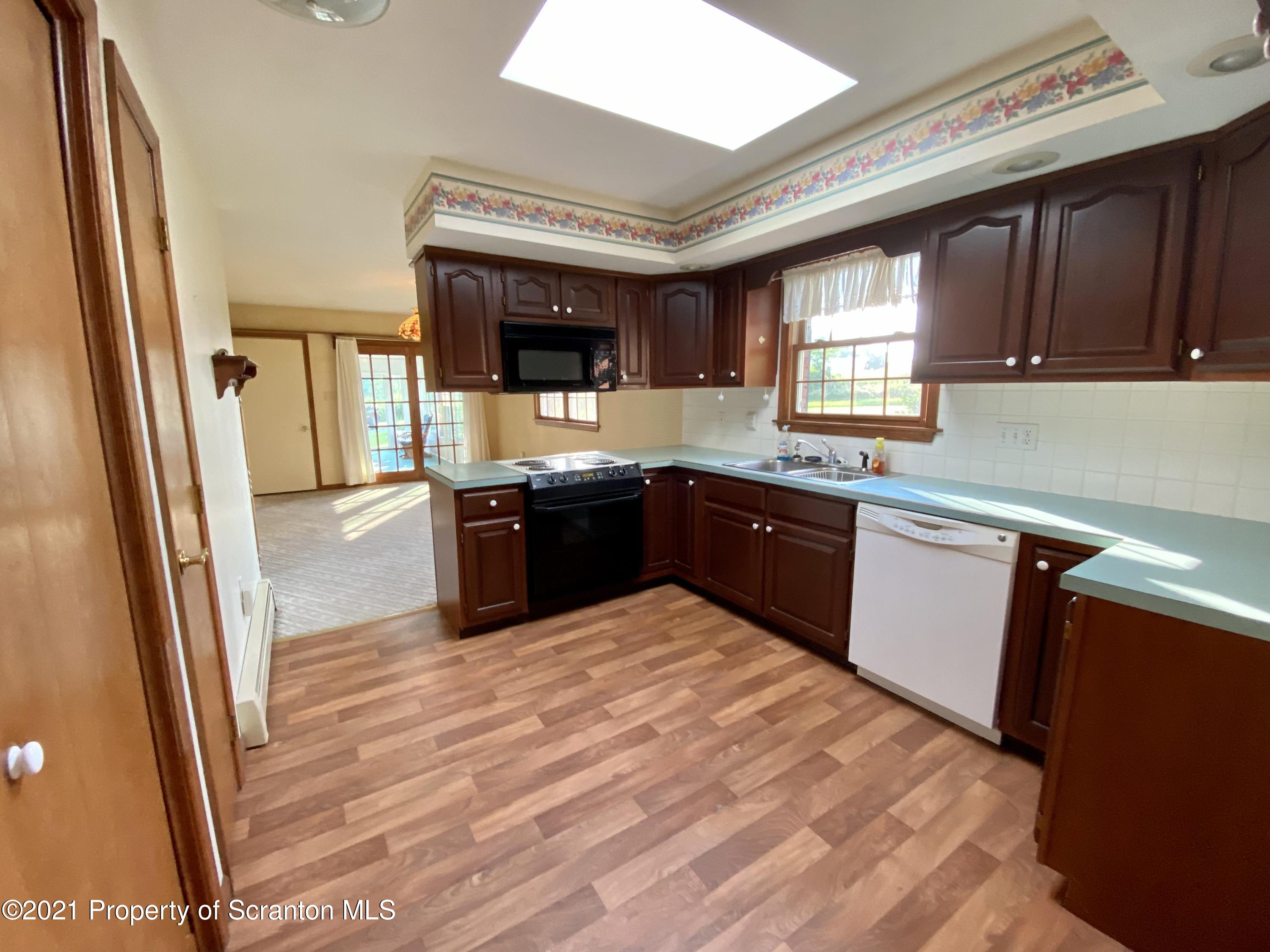 64 Thistle Hill Road Nicholson, PA 18446 - Photo 9 of 47 a large kitchen with stainless steel appliances granite countertop a sink and a refrigerator