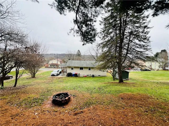 a view of backyard with large trees