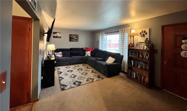a living room with furniture a ceiling fan and a window