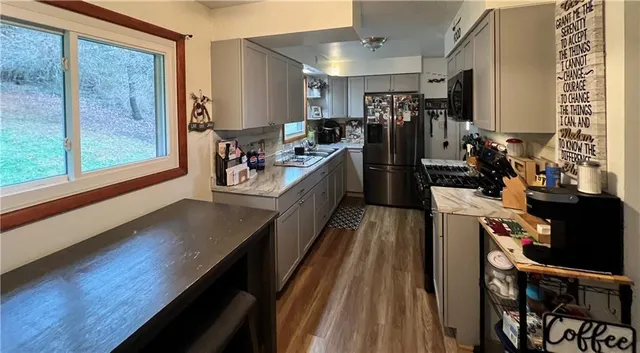 a bedroom with a bed and a flat tv screen on a dresser