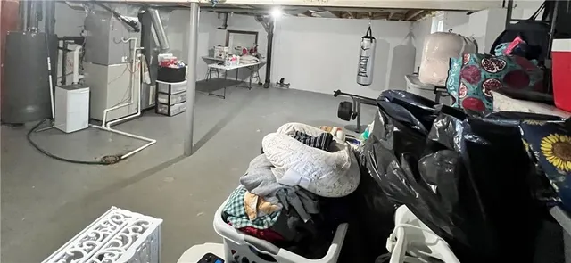 a view of an empty room with wooden floor and windows