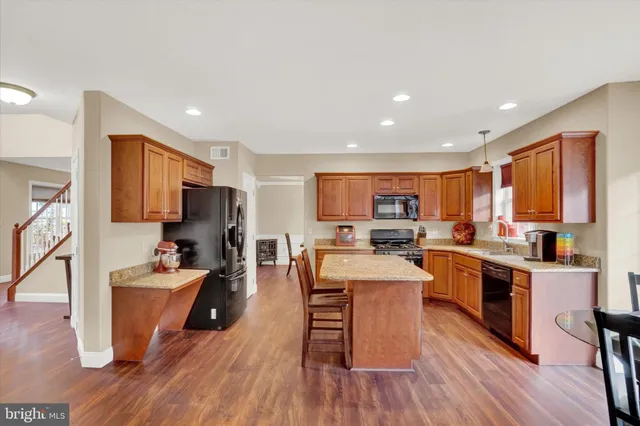 a kitchen with a sink a counter top space stainless steel appliances and cabinets