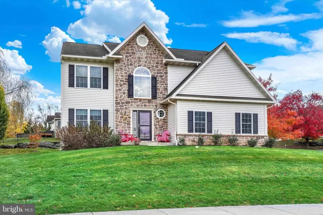 a front view of house with yard and green space