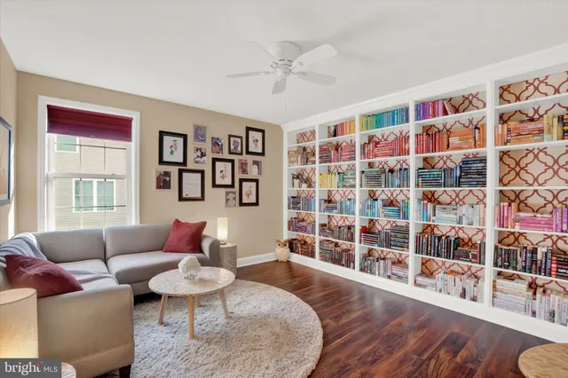 a living room with furniture and a book shelf