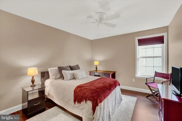 a bed room with a bed window and a chair