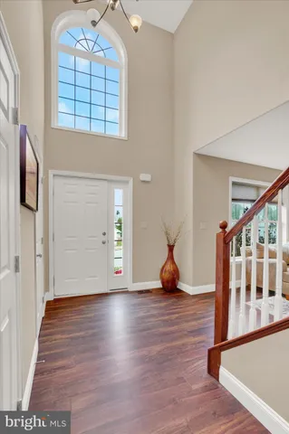 a view of an entryway with wooden floor