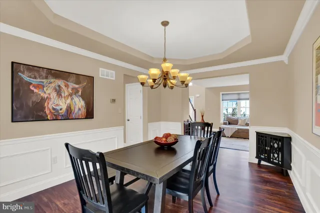 a view of a dining room with furniture wooden floor and chandelier