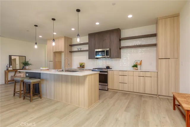 a kitchen with stainless steel appliances a stove and a microwave