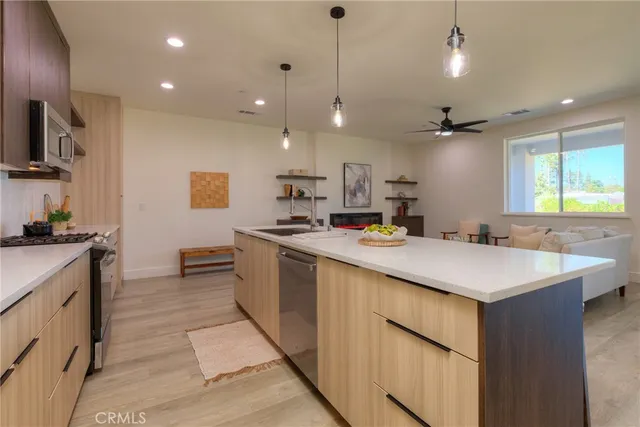 a living room with furniture and kitchen view