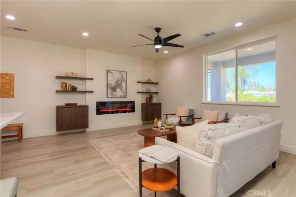 a living room with furniture and kitchen view