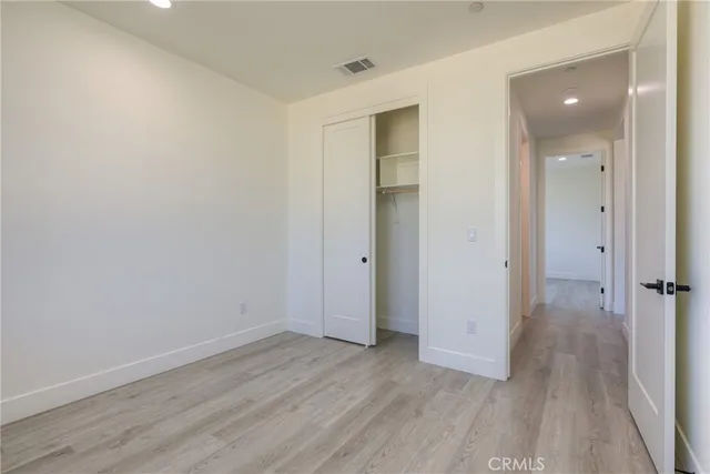 a kitchen with a sink cabinets and wooden floor