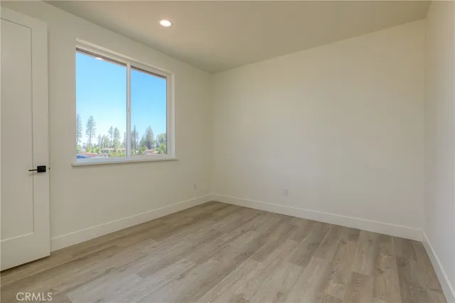 a kitchen with kitchen island granite countertop a stove a sink a refrigerator and a cabinets