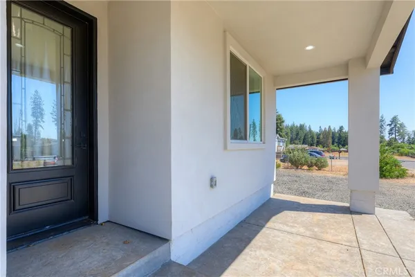 a view of a hallway with wooden floor windows and a bathroom