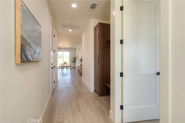 a living room with kitchen island furniture and a dining table with wooden floor