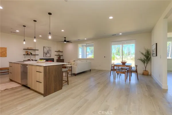 a kitchen with kitchen island wooden cabinets and refrigerator