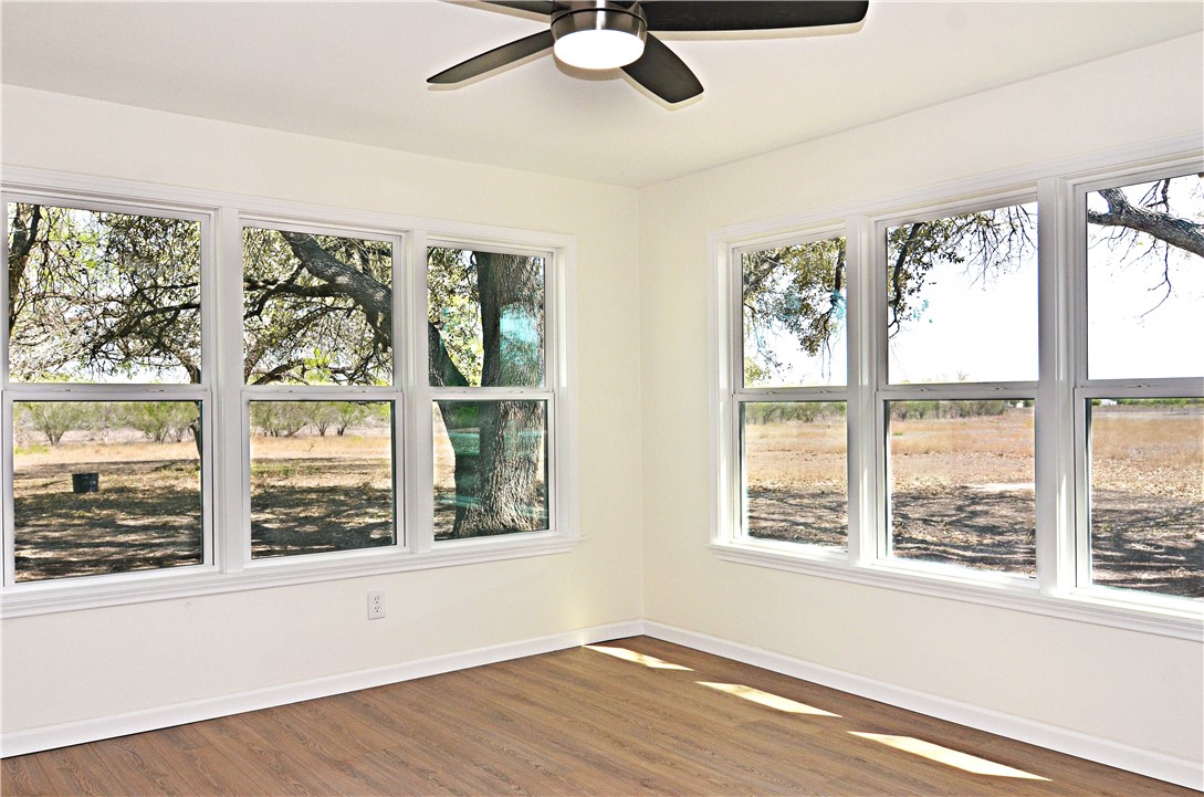 202 Ranch Road Mathis, TX 78368 - Photo 17 of 36 a view of an empty room with wooden floor and a window