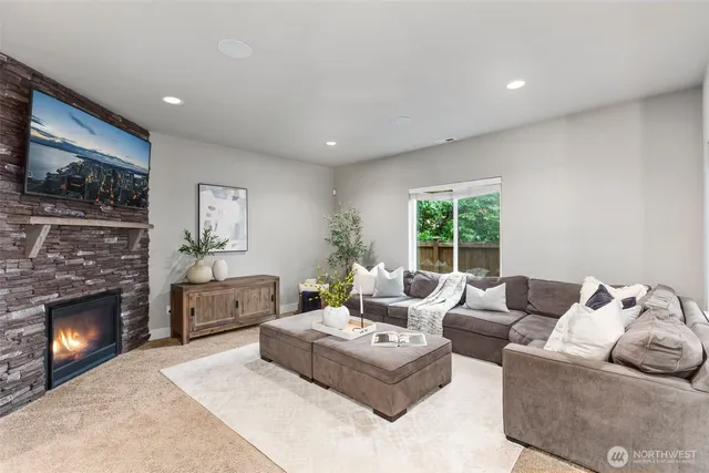 a living room with furniture window and a fireplace