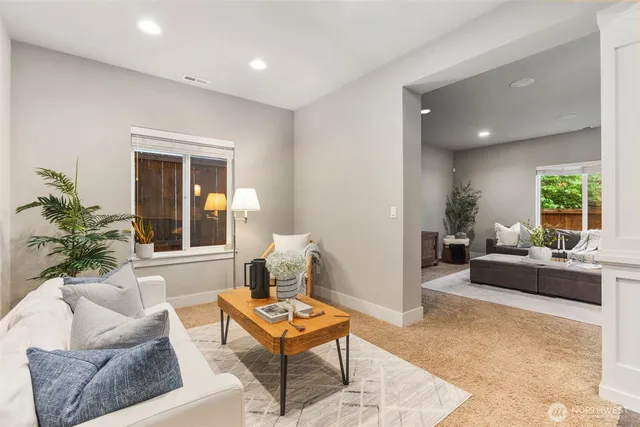 a living room with furniture and a potted plant