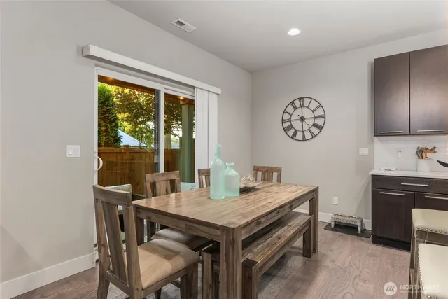 a view of a dining room with a table and chairs