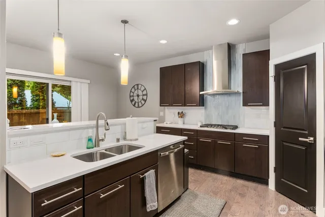 a kitchen with a sink appliances and cabinets