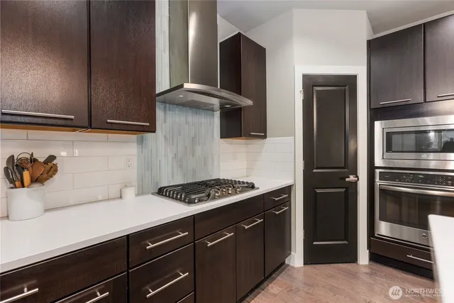 a kitchen with a refrigerator and a stove