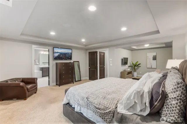 a spacious bedroom with a bed and a large mirror