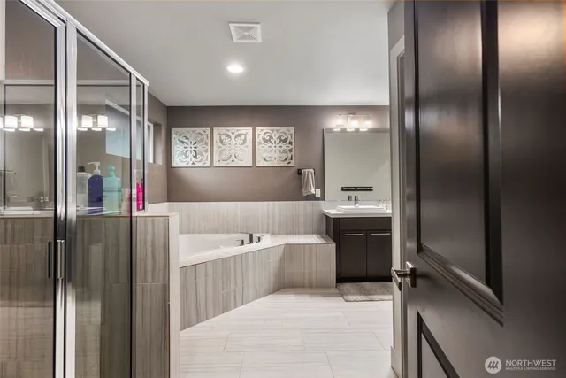 a large bathroom with a tub and shower