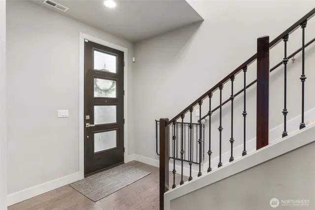 a view of staircase with rug door