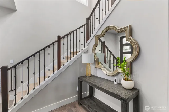 a view of staircase with wooden floor and a potted plant
