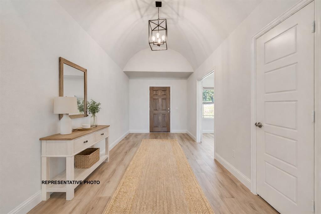 1036 Monaco Court Springtown, TX 76082 - Photo 2 of 12 a hallway with a sink and a mirror
