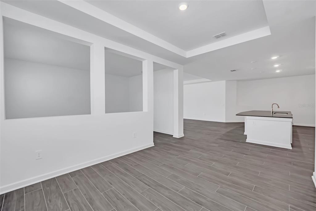 5768 Stephens Road St. Cloud, FL 34771 - Photo 22 of 50 a view of an empty room with wooden floor and a window