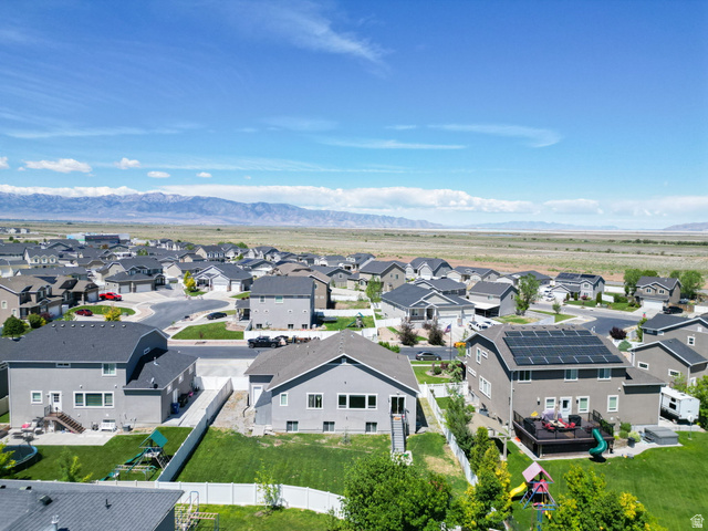 6062 Spring Street Stansbury Park, UT 84074 - Photo 36 of 36 Residential neighborhood with mountain backdrop, featuring a cul-de-sac and multiple properties with solar panel installations