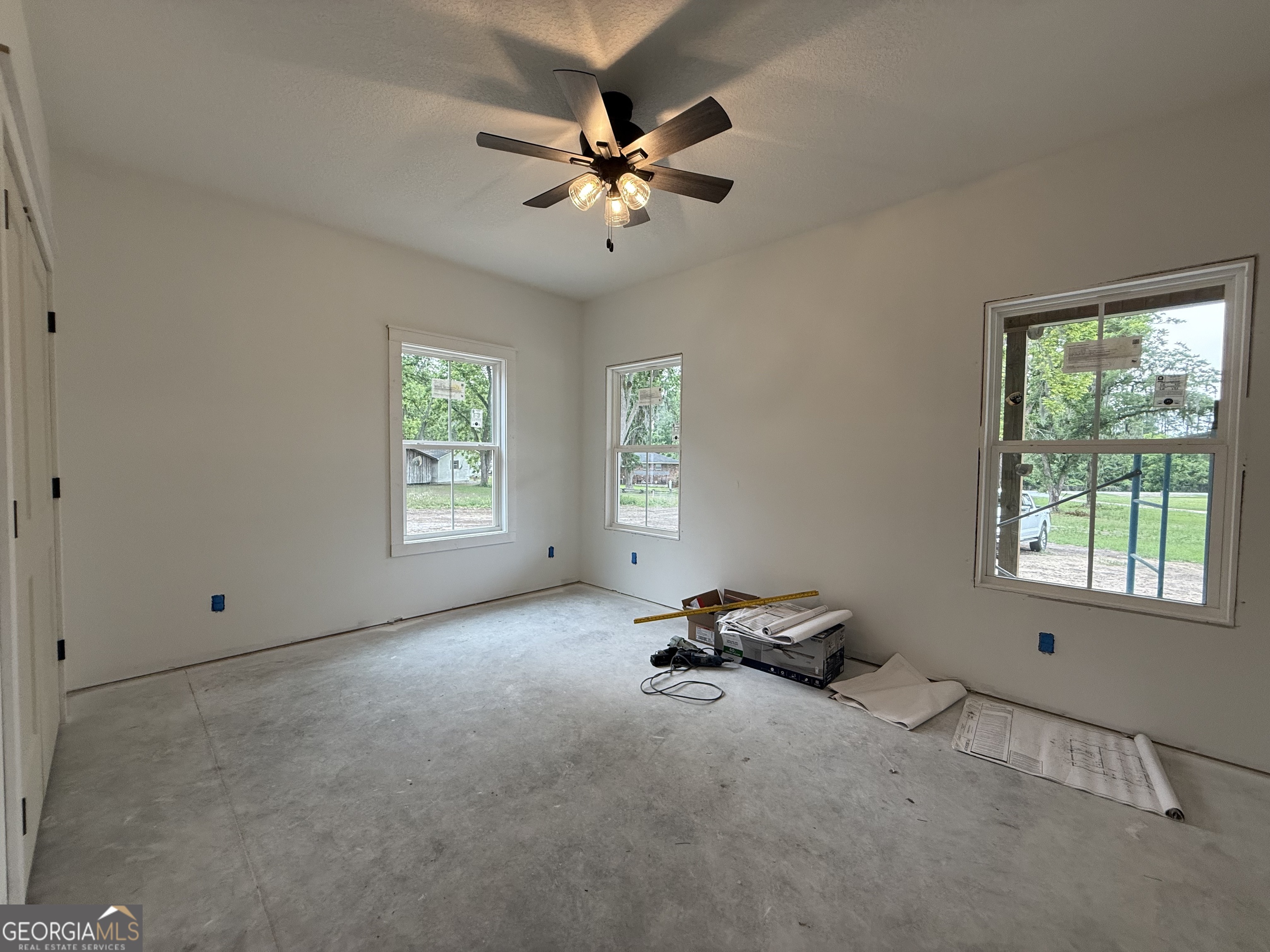 3411 Bob Bowen Road Blackshear, GA 31516 - Photo 8 of 13 a view of a livingroom with a window and a ceiling fan