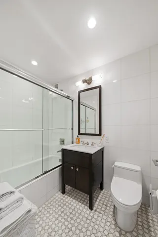 a bedroom with bed and a flat tv screen