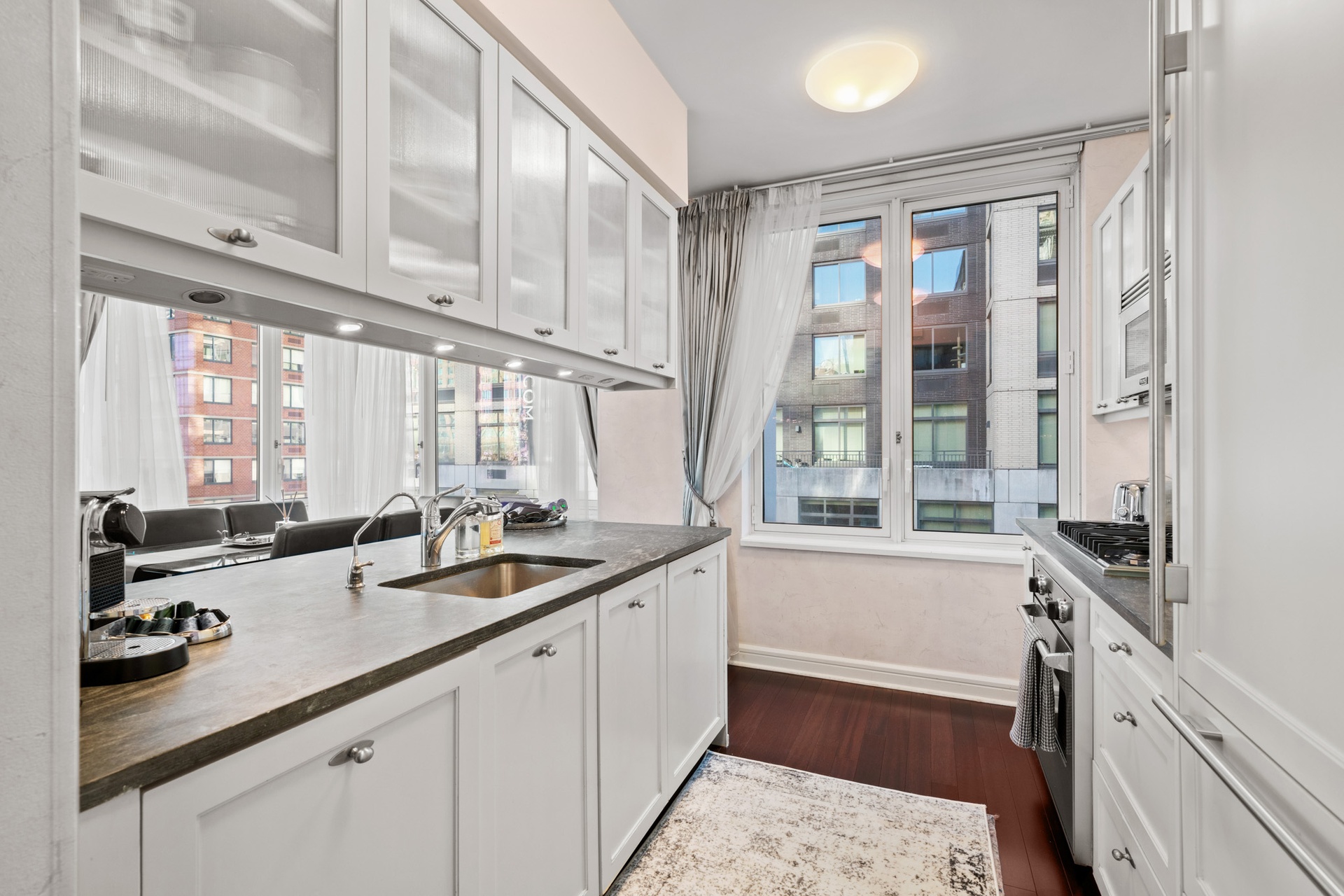 80 Riverside Boulevard, Unit 5S Manhattan, NY 10069 - Photo 6 of 24 a kitchen with a sink and a stove top oven