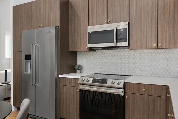 a kitchen with stainless steel appliances a stove a microwave and a refrigerator