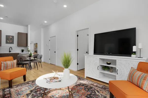 a living room with furniture and a flat screen tv