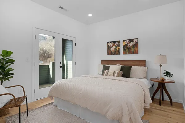 a bedroom with bed and a potted plant