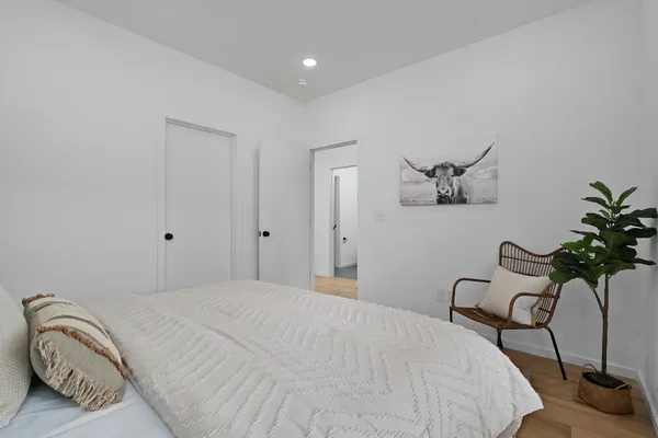 a bedroom with a bed and a potted plant