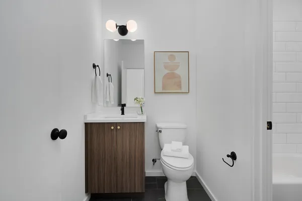 a bathroom with a sink toilet and shower
