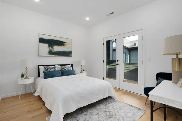 a bedroom with a bed and a mirror