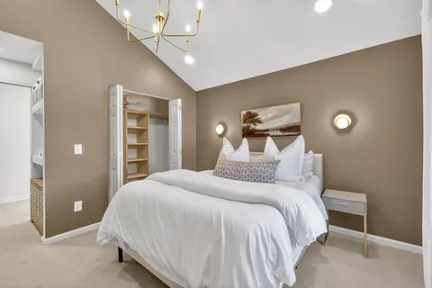 a bedroom with a bed and a ceiling fan