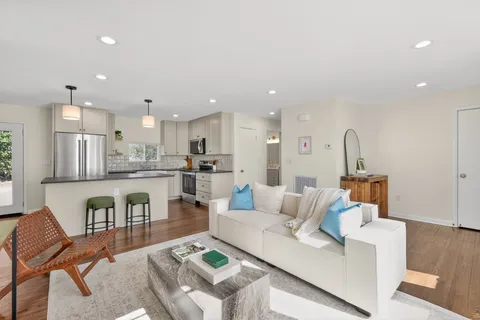 a kitchen with refrigerator a sink and chairs