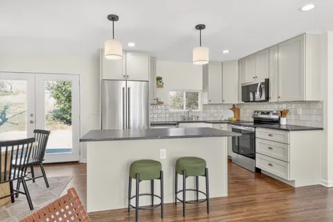 a kitchen with sink cabinets and dining table