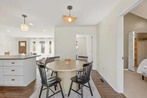 a dining room with furniture and wooden floor