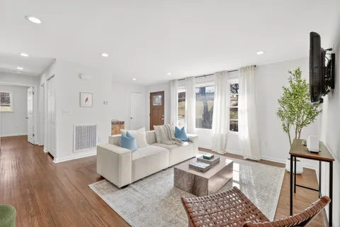 a living room with furniture and kitchen view